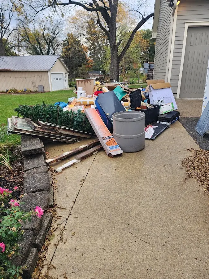 Dumpster being loaded with debris for Roofing Dumpster Rental in Wyoming